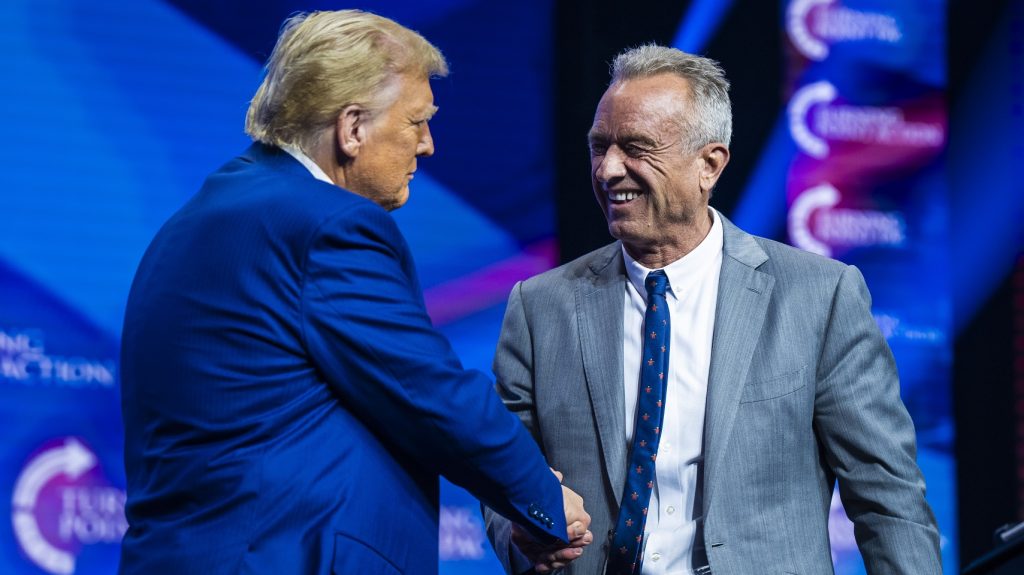 Robert F. Kennedy Jr. speaks with the now President-elect Donald Trump at a Turning Point Action Rally in Duluth, Georgia, on 23 October 2024.